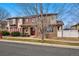 Charming townhouse with stone accents, red shutters, and well-maintained front lawn in a residential area at 11307 Navajo Cir # A, Westminster, CO 80234