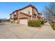 A multi-unit building with attached garages and appealing architecture, showcasing convenient parking and stylish design at 11307 Navajo Cir # A, Westminster, CO 80234