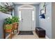 Bright foyer featuring neutral paint, decorative plants, tile flooring, and a white front door at 11307 Navajo Cir # A, Westminster, CO 80234