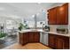 Open kitchen featuring an eat-in bar, wood cabinets and stainless steel appliances at 11307 Navajo Cir # A, Westminster, CO 80234