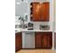 Kitchen features a dishwasher, cherry wood cabinets, and white subway tile backsplash at 11307 Navajo Cir # A, Westminster, CO 80234