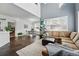 Open-concept living area with seamless flow to dining room, enhanced by large windows and high ceilings at 11307 Navajo Cir # A, Westminster, CO 80234