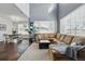 Open-concept living room with high ceilings, large windows, and seamless flow into the dining area at 11307 Navajo Cir # A, Westminster, CO 80234