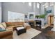 Spacious living area with high ceilings, large windows, and a cozy fireplace for a warm and inviting atmosphere at 11307 Navajo Cir # A, Westminster, CO 80234