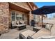 A cozy outdoor patio space with comfortable seating, a grill, and a shade umbrella for relaxation at 11307 Navajo Cir # A, Westminster, CO 80234