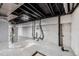 Unfinished basement showcasing utilities with exposed pipes and concrete walls at 11753 Pennsylvania St, Northglenn, CO 80233