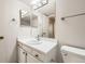 Bathroom with a single sink vanity, white cabinets, and ample counter space at 11753 Pennsylvania St, Northglenn, CO 80233