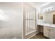 Bright bathroom featuring a modern vanity with wood-look flooring and a decorative privacy screen at 11753 Pennsylvania St, Northglenn, CO 80233