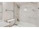 Modern bathroom featuring a shower over tub and marble style tile surround at 11753 Pennsylvania St, Northglenn, CO 80233