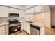 Modern kitchen featuring updated stainless steel appliances and granite countertops at 11753 Pennsylvania St, Northglenn, CO 80233