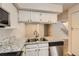 Updated kitchen with granite countertops, stainless steel appliances and white cabinets at 11753 Pennsylvania St, Northglenn, CO 80233