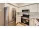 Well-equipped kitchen featuring stainless steel appliances and granite countertops at 11753 Pennsylvania St, Northglenn, CO 80233