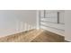 Bright room featuring hardwood floors and built-in shelving at 11753 Pennsylvania St, Northglenn, CO 80233