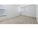 Spacious carpeted room with large windows providing ample natural light at 11753 Pennsylvania St, Northglenn, CO 80233