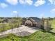Expansive driveway and lush green surroundings highlight this beautiful home at 1236 Castlecombe Ln, Monument, CO 80132