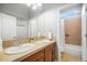 Bright bathroom with a double sink vanity and tiled shower at 1236 Castlecombe Ln, Monument, CO 80132