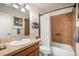Well-maintained bathroom featuring tiled shower, oak vanity, and updated fixtures at 1236 Castlecombe Ln, Monument, CO 80132