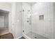 Modern bathroom featuring a glass shower with white tiled walls and built-in toiletry storage at 1236 Castlecombe Ln, Monument, CO 80132