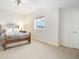 Neutral bedroom with ornamental iron bed frame, plush carpeting, and ample natural light at 1236 Castlecombe Ln, Monument, CO 80132