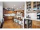 Well-appointed kitchen with stainless steel appliances, quartz countertops and wine refrigerator at 1236 Castlecombe Ln, Monument, CO 80132