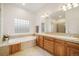 Bright main bathroom featuring a soaking tub and dual sinks set in wood cabinetry at 1236 Castlecombe Ln, Monument, CO 80132