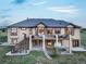 A two-story home with a brown exterior, complemented by a spacious backyard, wooden deck, and a hot tub at 1236 Castlecombe Ln, Monument, CO 80132