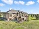 A two-story home with a tan exterior, complemented by a spacious backyard, wooden deck, and a hot tub at 1236 Castlecombe Ln, Monument, CO 80132