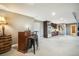 Basement wet bar featuring stainless steel refrigerator and custom dark-wood cabinets at 1236 Castlecombe Ln, Monument, CO 80132
