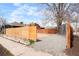 Backyard lot with fence and parking area near trees and residential home at 3600 N Race St, Denver, CO 80205