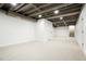 Spacious finished basement with an exposed ceiling, new carpet, neutral paint, and recessed lighting at 3600 N Race St, Denver, CO 80205