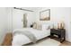Bright bedroom featuring a sliding barn door to the bathroom, neutral colors, and modern decor at 3600 N Race St, Denver, CO 80205