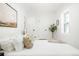 Bright bedroom with white walls, a large window, and modern décor with a decorative tree at 3600 N Race St, Denver, CO 80205