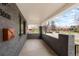 Covered brick porch with room for seating and neighborhood views at 3600 N Race St, Denver, CO 80205