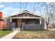 Charming single-story home with a gray brick facade and a yellow front door at 3600 N Race St, Denver, CO 80205