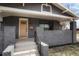 Charming home featuring an attractive painted brick exterior, covered front porch, and well-manicured landscaping at 3600 N Race St, Denver, CO 80205