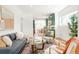 Open-concept living room with modern furnishings and hardwood floors, leading to kitchen at 3600 N Race St, Denver, CO 80205