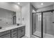 Modern bathroom featuring double vanity, walk-in shower with glass door, and sleek fixtures at 1415 Great Western Dr, Longmont, CO 80501