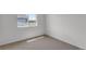 Neutral bedroom features a window allowing natural light over plush carpeting at 1415 Great Western Dr, Longmont, CO 80501
