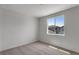 Cozy bedroom with neutral carpet, a large window, and ample natural light at 1415 Great Western Dr, Longmont, CO 80501