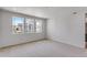 Comfortable bedroom featuring neutral carpeting and large windows providing natural light at 1415 Great Western Dr, Longmont, CO 80501