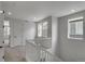 Upstairs hallway with white railing, neutral carpet, and access to several rooms at 1415 Great Western Dr, Longmont, CO 80501