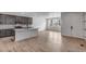 Contemporary kitchen featuring wood floors, stainless steel appliances, a center island, and open floor plan at 1415 Great Western Dr, Longmont, CO 80501