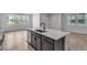 Kitchen island with seating, a sink, and a dishwasher provides an open space in the kitchen at 1415 Great Western Dr, Longmont, CO 80501