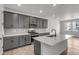 Kitchen featuring an island, gray cabinetry, tile backsplash, and stainless steel appliances at 1415 Great Western Dr, Longmont, CO 80501