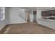 Spacious living area with wood floors, open staircase, and seamless flow into a modern kitchen at 1415 Great Western Dr, Longmont, CO 80501