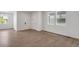 Bright living room featuring hardwood floors and large windows allowing for ample natural light at 1415 Great Western Dr, Longmont, CO 80501