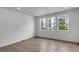 Bright living room with wood floors, recessed lighting, and large windows offering a view of the outdoors at 1415 Great Western Dr, Longmont, CO 80501