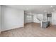 Open concept living space with wood floors, a modern staircase, and flowing layout to the kitchen area at 1415 Great Western Dr, Longmont, CO 80501