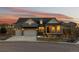 Charming craftsman-style home with a covered porch and a three-car garage at sunset at 36 Stableford Pl, Castle Pines, CO 80108