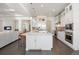 Kitchen with stainless steel appliances, expansive island with seating, and modern finishes at 36 Stableford Pl, Castle Pines, CO 80108